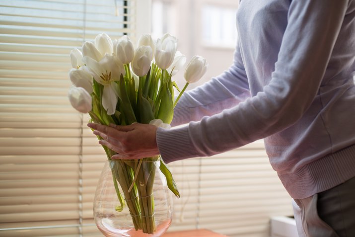 Woman arranging tulips in a vase