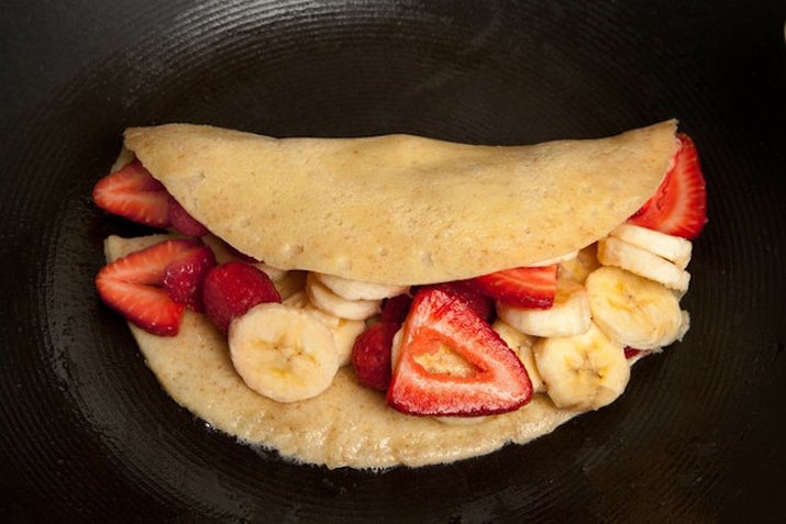 Crepe filled with strawberry and banana slices.