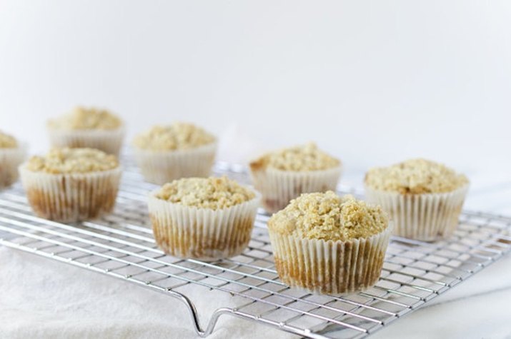 Wire rack with several streusel-topped muffins.