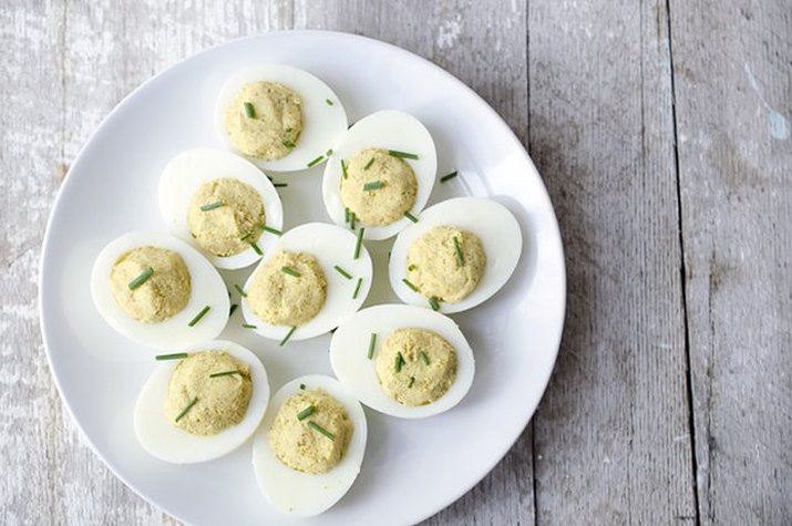 Deviled eggs topped with chives.