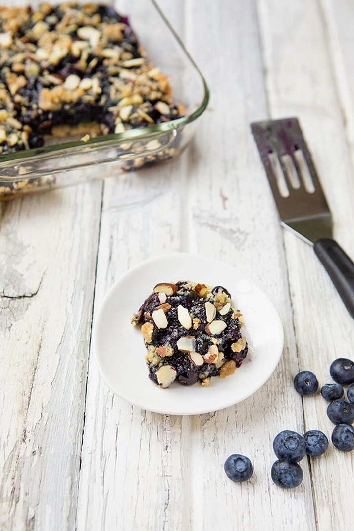 A coconut almond blueberry crumb bar on a plate.