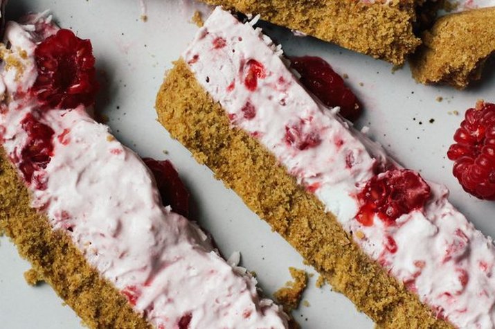 Crumbly raspberry coconut cream bars lying together side-by-side.