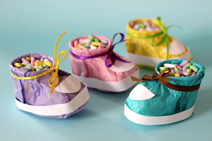 Baby booties made out of tissue paper, filled with candy.