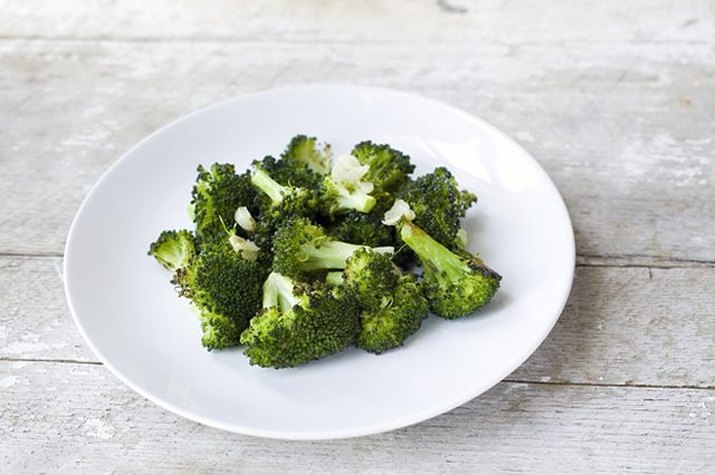 A plate of deep green roasted broccoli.