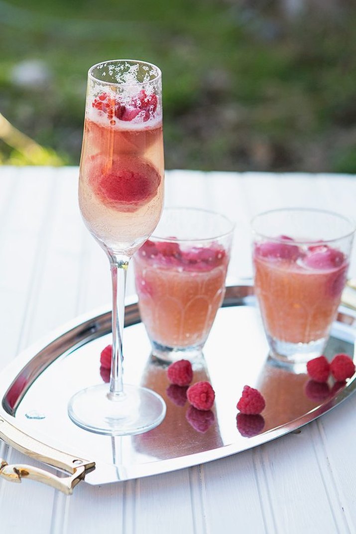 Glasses of raspberry sorbetto mimosas.