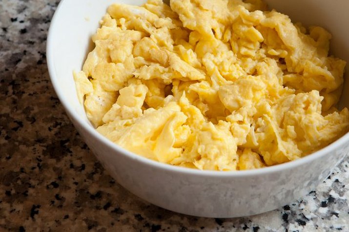 A bowl of perfectly textured scrambled eggs.