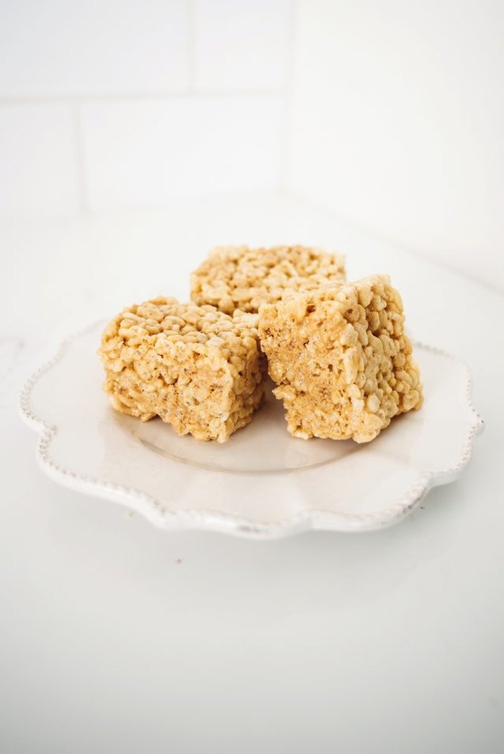 Three squares of soft and chewy rice krispie treats.
