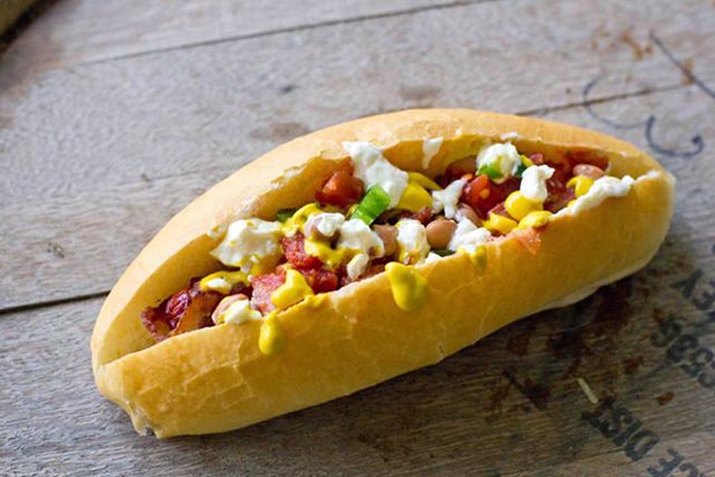A classic, southwestern Sonoran dog topped with pinto beans, onions, jalapenos, cream sauce and mustard.