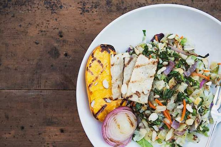 A refreshing plate of grilled chopped salad with mango and red onion.
