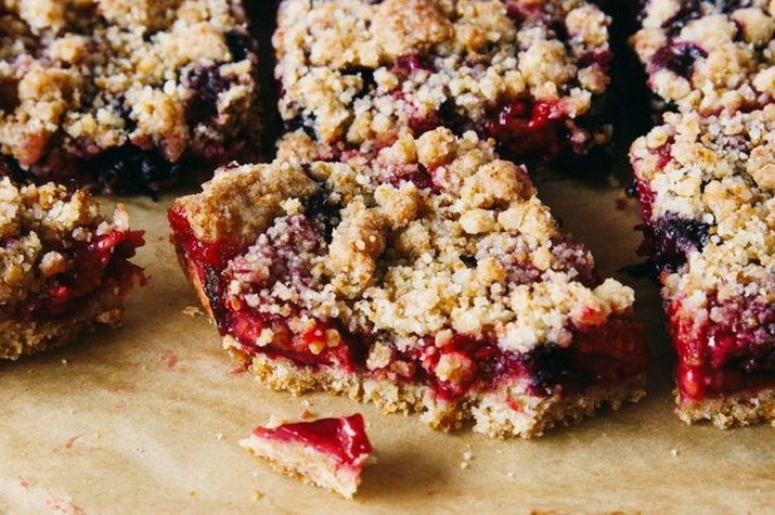 Squared crumb bars oozing with baked berry filling.