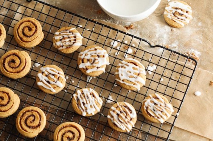 Baked sweet potato cinnamon roll cookies iced with frosting.