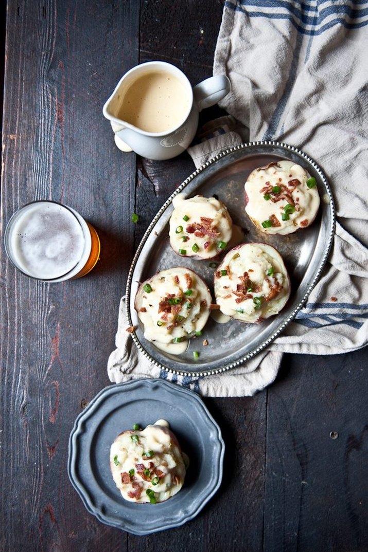 Twice-baked beer cheese red potatoes topped with green onions and bacon.