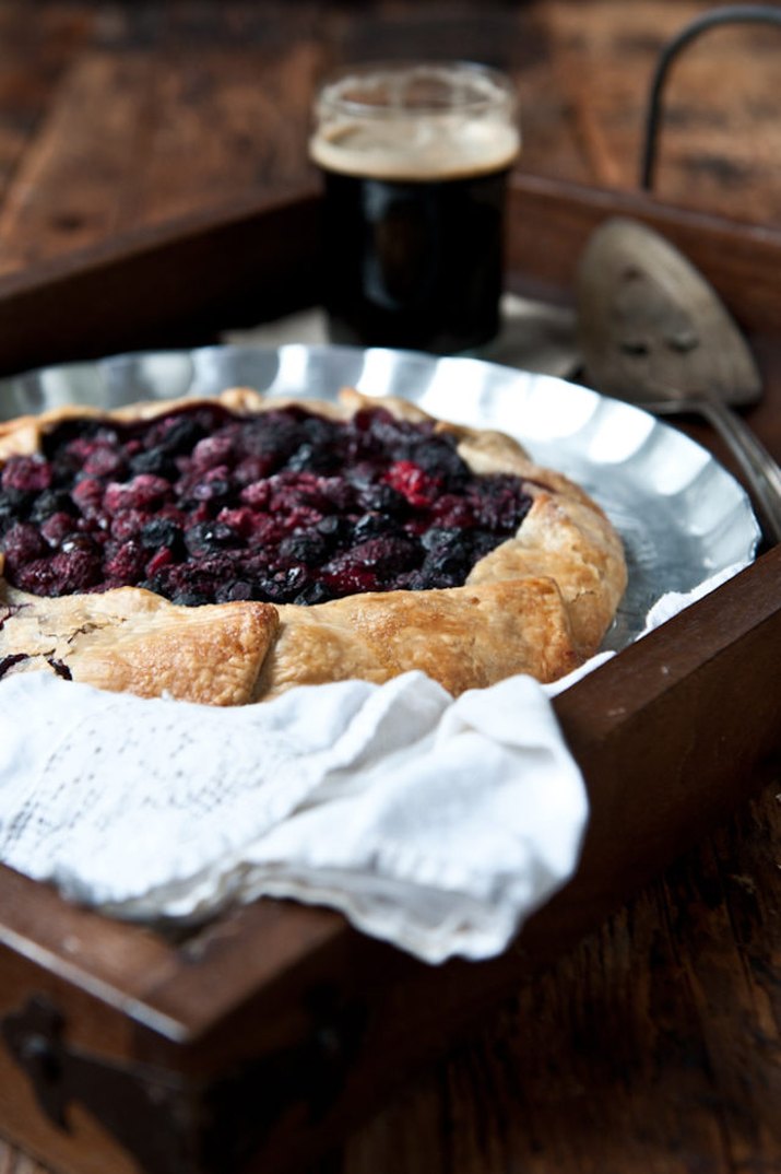 Chocolate stout and mixed berry galette in a silver pie plate.