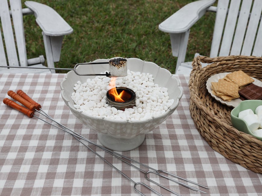 Roasting a marshmallow over a tabletop fire pit
